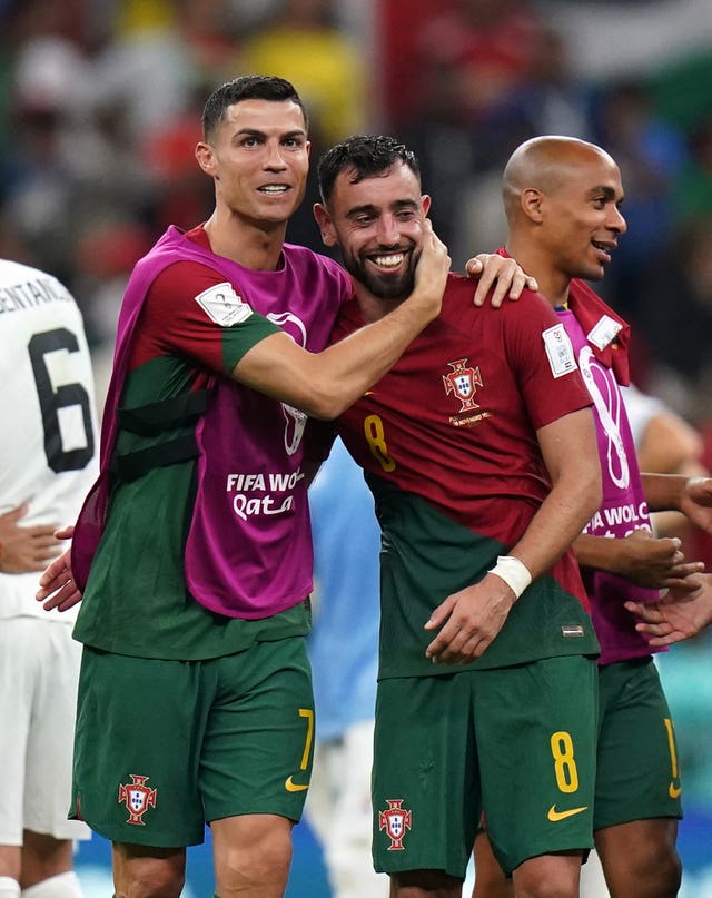 Portugal’s Cristiano Ronaldo (left) and Bruno Fernandes embrace after the Group H win over Uruguay