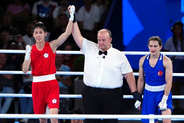 Lin Yu-ting has her hand raised after victory over Esra Yildiz Kahraman