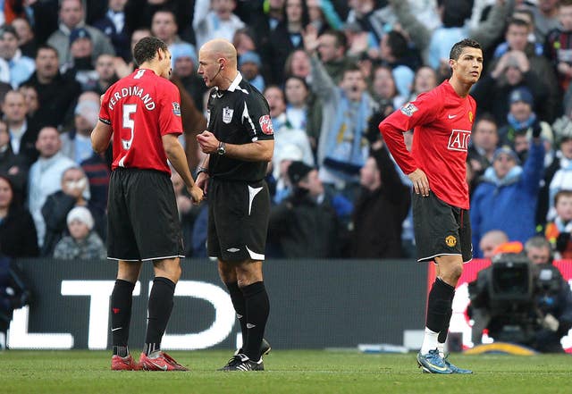 Manchester United’s Cristiano Ronaldo is sent off at Manchester City as referee Howard Webb explains the decision to Rio Ferdinand