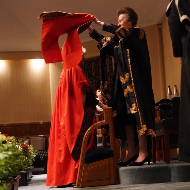 The Princess Royal placed a hood over her sister-in-law's hair 