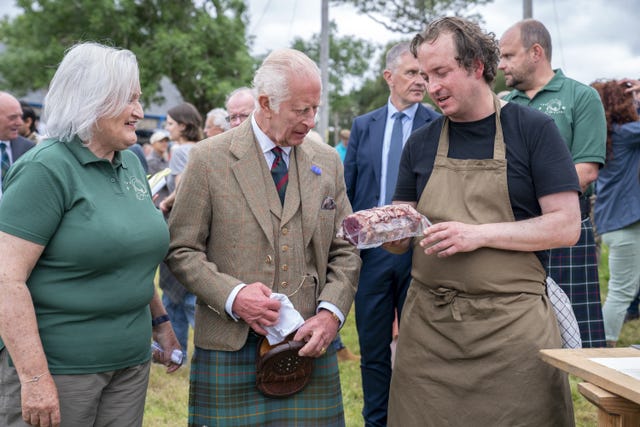 King Charles handed some venison by a chef