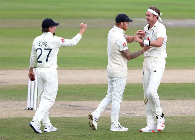 England’s Stuart Broad, right, celebrates with Ben Stokes and Rory Burns