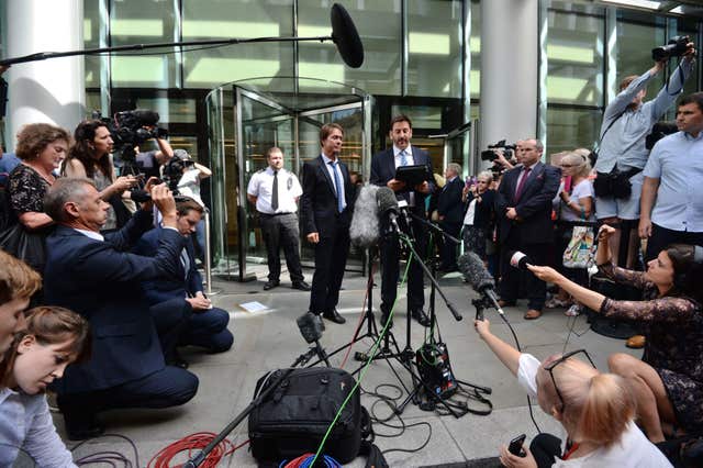 Sir Cliff Richard (centre) with his lawyer, Gideon Benaim, outside the Rolls Building in London