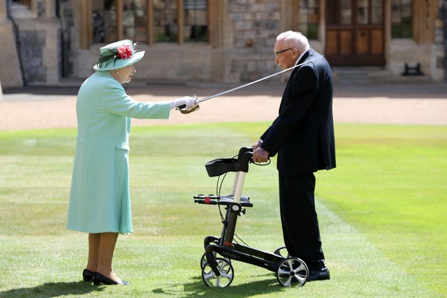 Sir Thomas Moore receiving his knighthood from Queen Elizabeth II during a ceremony at Windsor Castle in 2020 