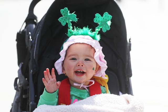 Grace Wang, 18 months, dressed up to celebrate St Patrick’s Day on O’Connell Street (Brian Lawless/PA)