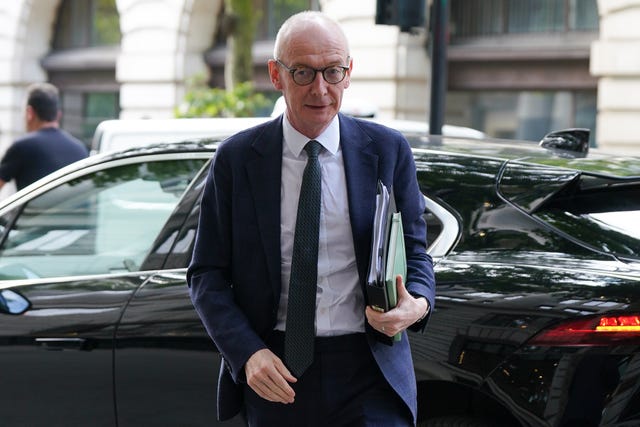 Cabinet Office minister Pat McFadden steps out of a car carrying folders under his arm