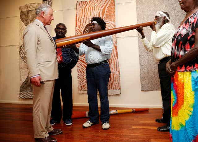 The Prince of Wales takes part in a didgeridoo demonstration during a visit to the Buku-Larrnggay Mulka Centre in Yirrkala, in Australia’s Northern Territory