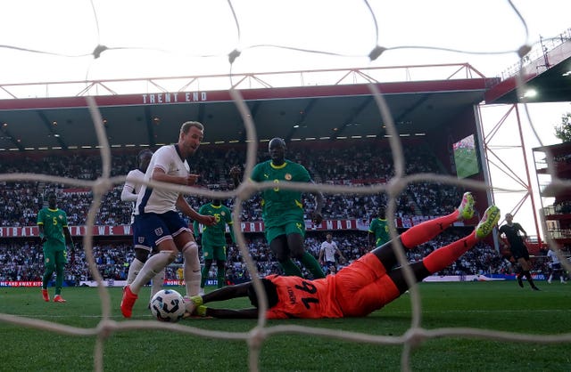 Harry Kane, left, scores England's opener against Senegal