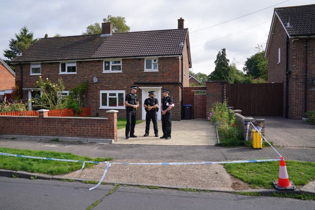 Surrey Police officers outside a property on Hammond Road in Woking
