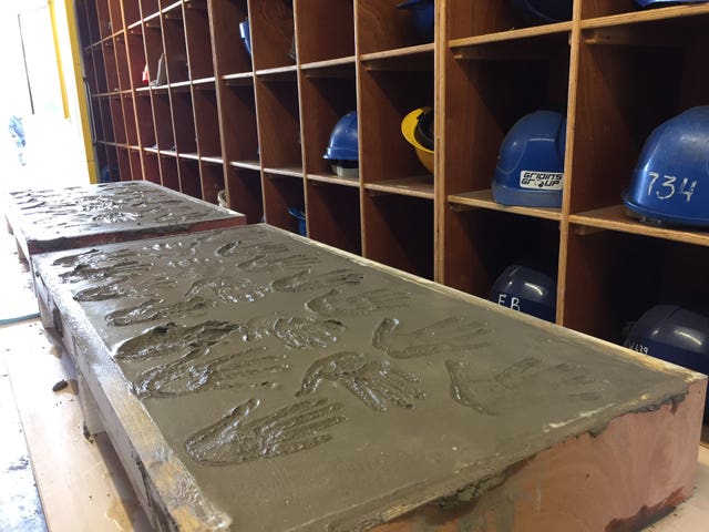 Handprints left by former shipyard workers in wet cement 