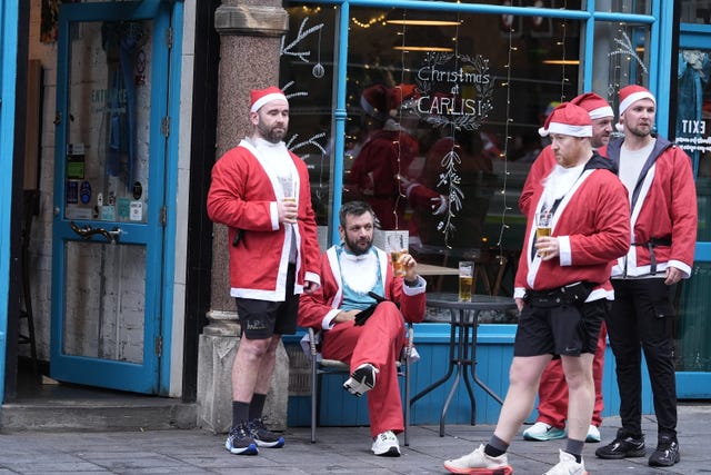 Santas enjoy a beer after the race