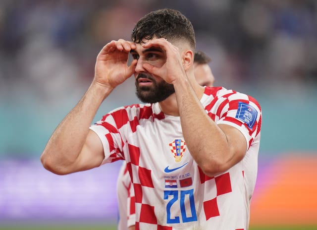Croatia’s Josko Gvardiol puts his hands over his eyes to shield the sun during the FIFA World Cup third place play-off match 