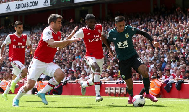 Arsenal and Burnley players battle for possession