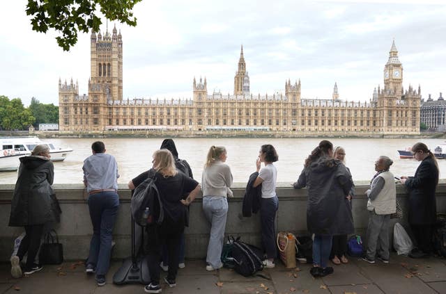 Members of the public join the queue as they wait to view the Queen lying in state