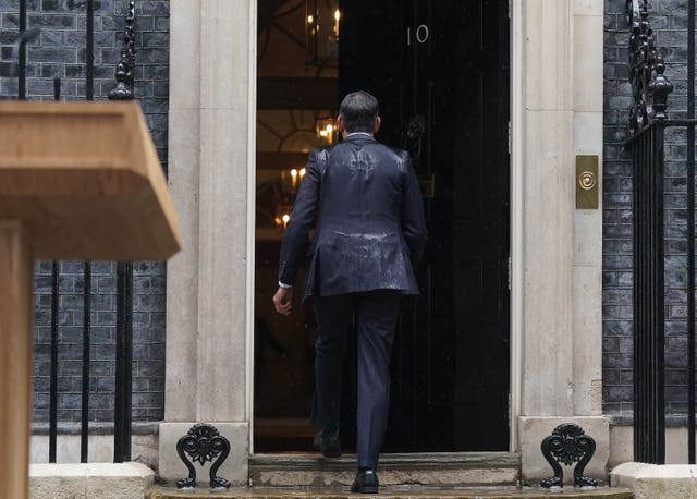 A back view of Rishi Sunak entering No 10 after his announcement that he is calling an election