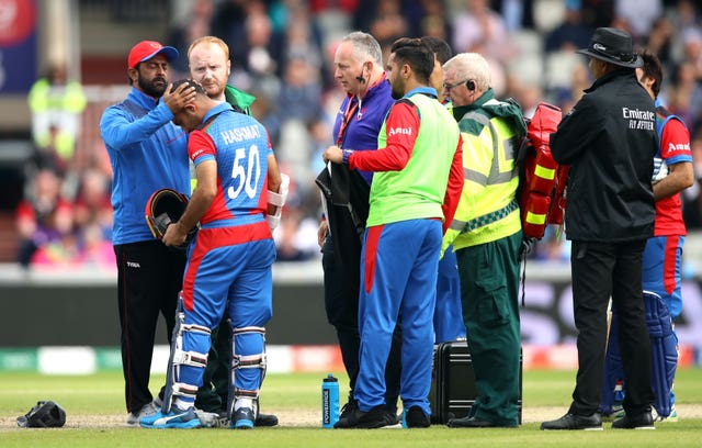 Hashmatullah is assessed by medical staff after being struck by the ball