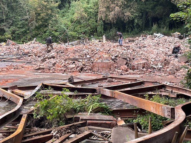 People inspect the remains of The Crooked House pub in Himley, near Dudley