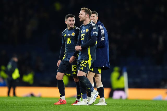 Nicky Devlin shares a joke with his Scotland team-mates after making his debut against Portugal