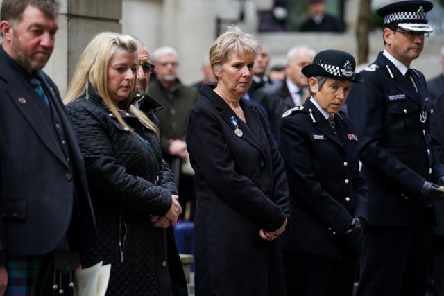 Metropolitan Police Commissioner Dame Cressida Dick (second right), and Victoria Morrison (centre), Jim Morrison’s widow, during the memorial on Monday