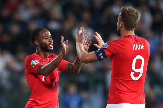 Raheem Sterling celebrates scoring his side’s fifth goal with Harry Kane 