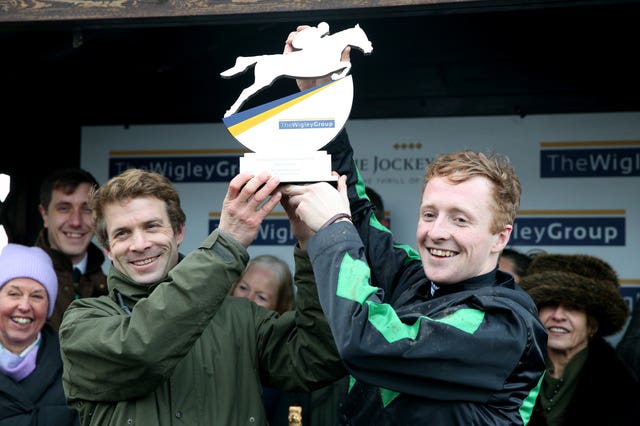 Jockey Stan Sheppard and trainer Sam Thomas celebrate after Iwilldoit won The Wigley Group Classic Handicap Chase during at Warwick 