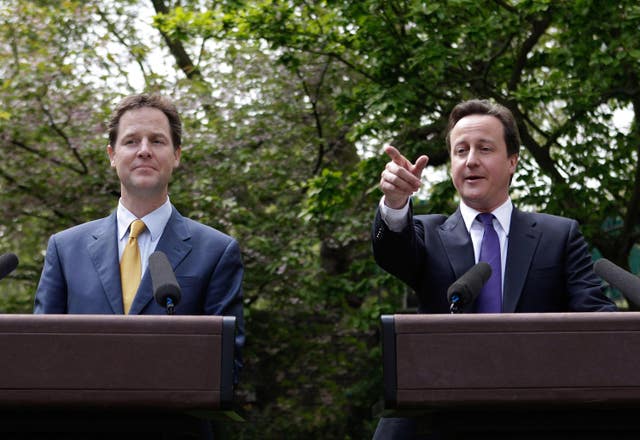 Nick Clegg and David Cameron speaking from behind podiums in the garden of No 10