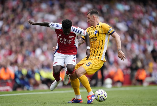 Lewis Dunk battles for the ball