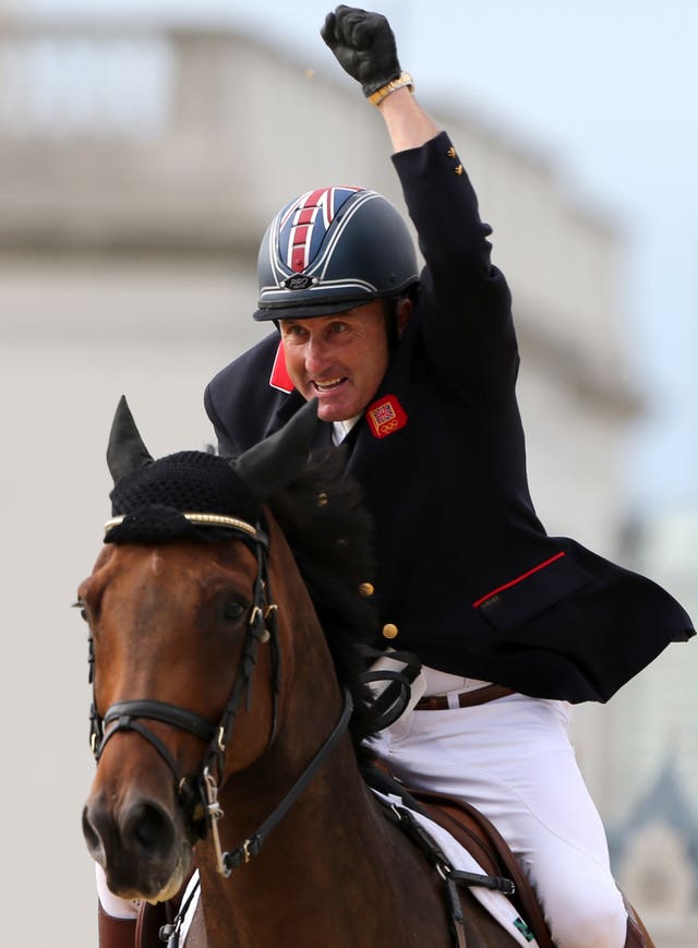 Peter Charles, Harry's father, riding Vindicat celebrates winning in London in 2012.