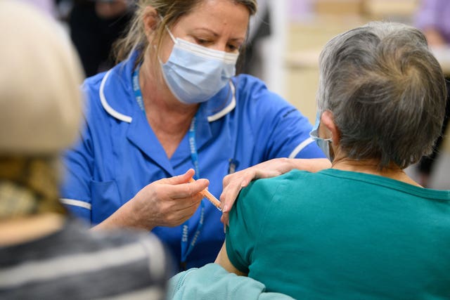 A member of a medical team administers a Covid-19 vaccine injection
