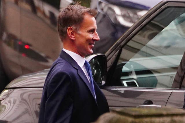 Chancellor Jeremy Hunt getting into a car at the rear of Downing Street before making his emergency statement 