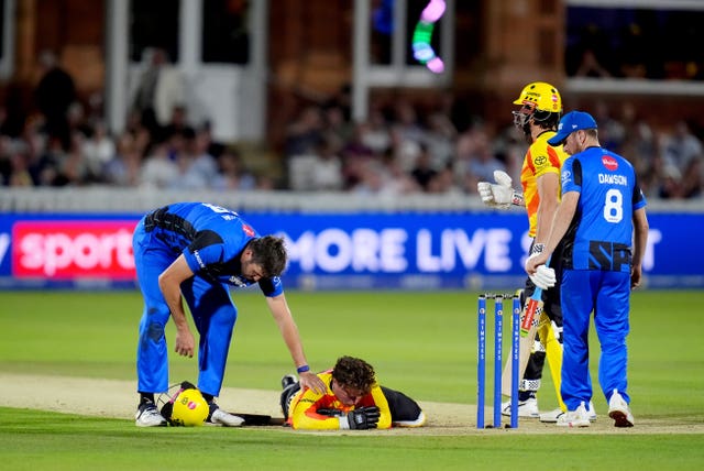 Jamie Overton checks on Tom Alsop after he was hit on the nose 