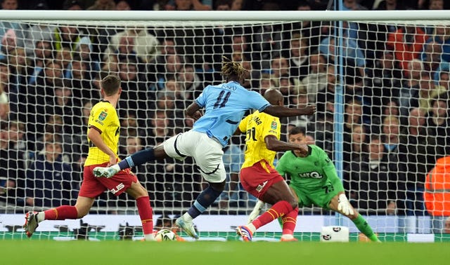 Jeremy Doku, centre, scores Manchester City’s first goal against Watford