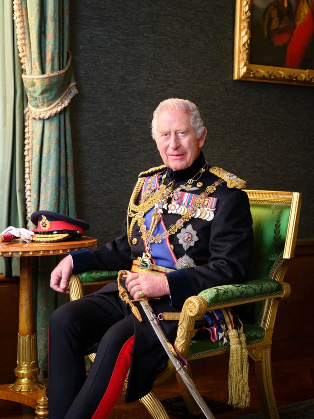 The King in uniform and seated