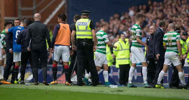 Celtic's Scott Brown is guided down the tunnel after an argument with Rangers manager Pedro Caixinha