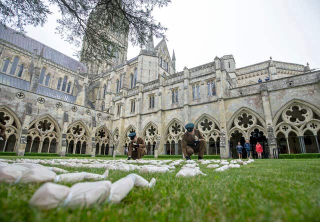 The shrouds were laid out at the heart of the cathedral cloisters (Steve Parsons/PA)