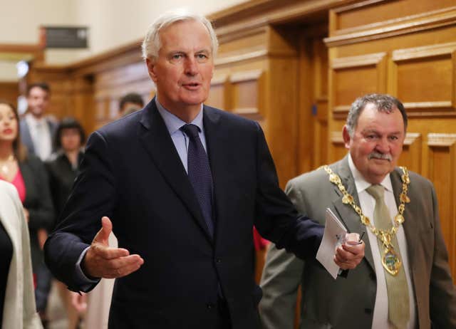 Michel Barnier is greeted by Mayor Maoliosa McHugh as he arrives at the Guildhall in Derry (Niall Carson/PA)