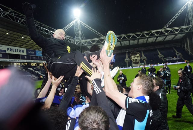 Then Leicester manager Enzo Maresca is lifted up as the team celebrate securing the Championship title 