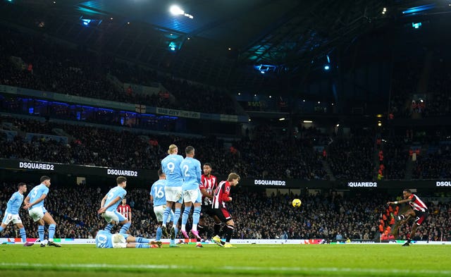 Brentford’s Ivan Toney, right, takes a free-kick against Manchester City