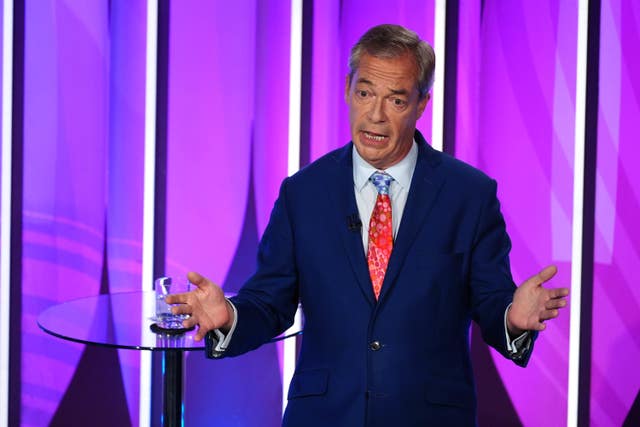 Nigel Farage on stage gesturing