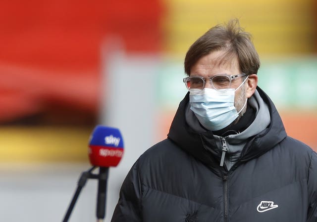 Liverpool manager Jurgen Klopp wears a mask while being interviewed