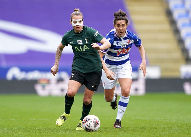 Tottenham’s Ria Percival, left, sports a protective mask as she battles for possession with Reading’s Fara Williams in the Women's Super League