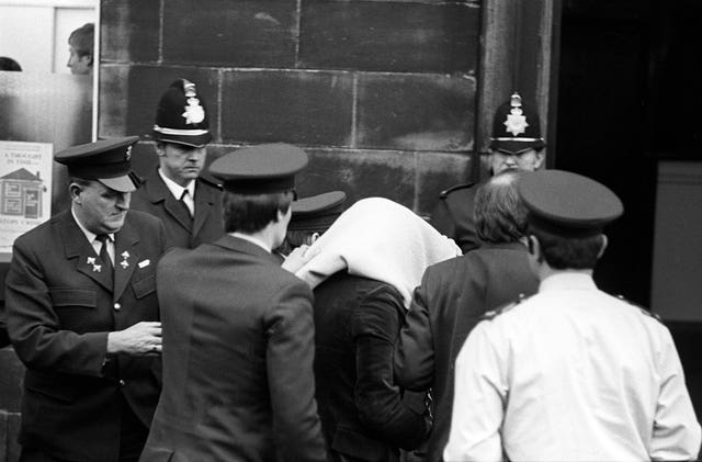 Peter Sutcliffe, under a blanket, arriving at Dewsbury Magistrates Court (PA) 