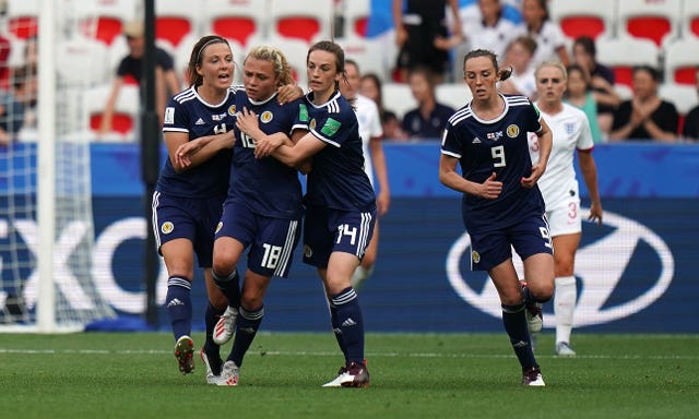 Claire Emslie, centre left, celebrates scoring against England 