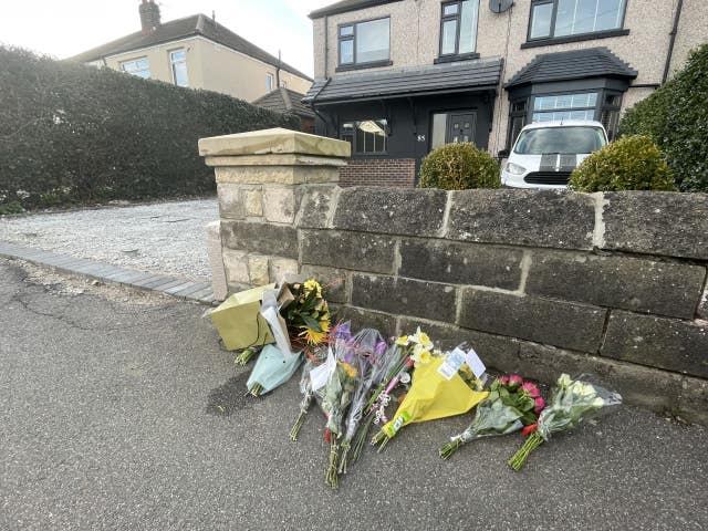 Floral tributes left outside a house on Hemper Lane, Greenhill 