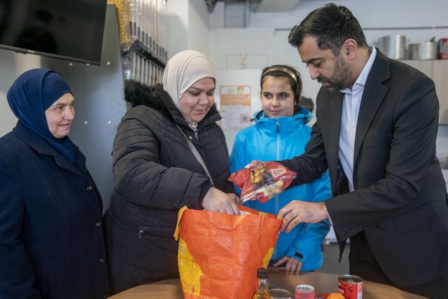First Minister of Scotland Humza Yousaf meets members of the local community during a visit to the Whitfield Community Larder in Dundee, as part of The Big Help Out