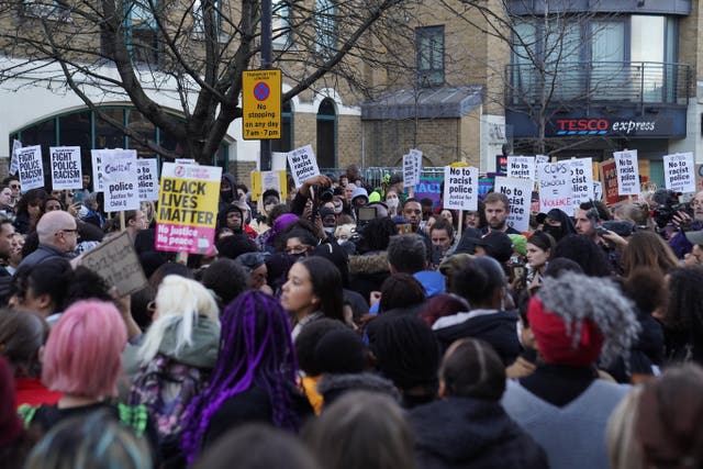 People demonstrate outside Stoke Newington police station in London over the treatment of a black 15-year-old schoolgirl who was strip-searched by police while on her period