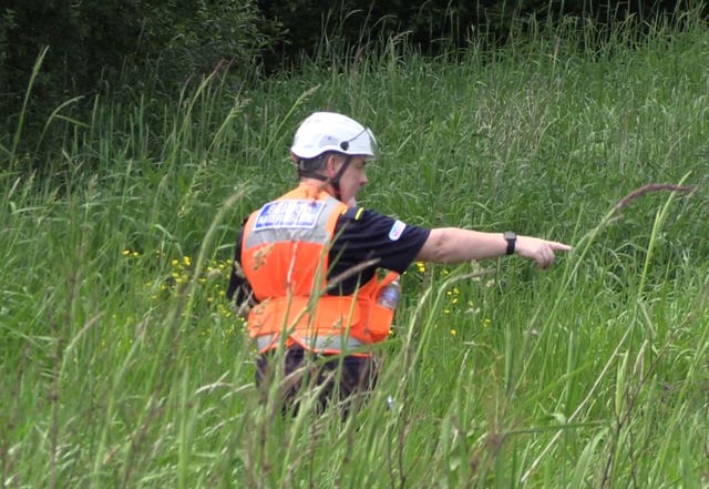 Community Rescue Service volunteers in thick undergrowth on the banks of the River Braid