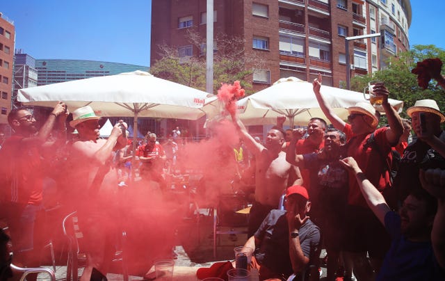 Liverpool fans set off a smoke flare in the Plaza de Felipe II