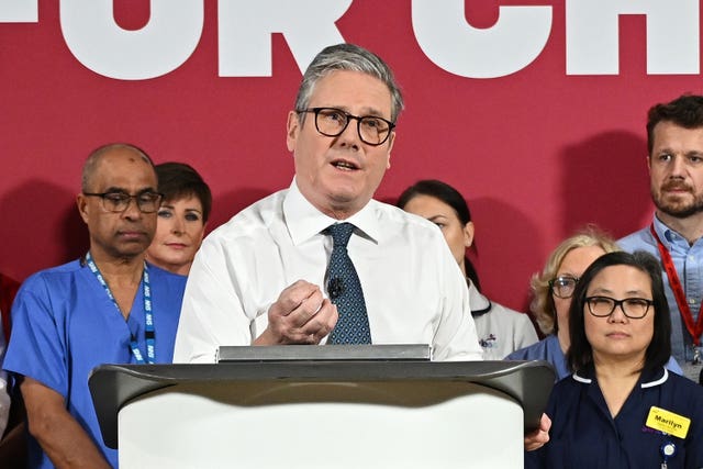 Sir Keir Starmer speaks from a podium during a visit to Surrey