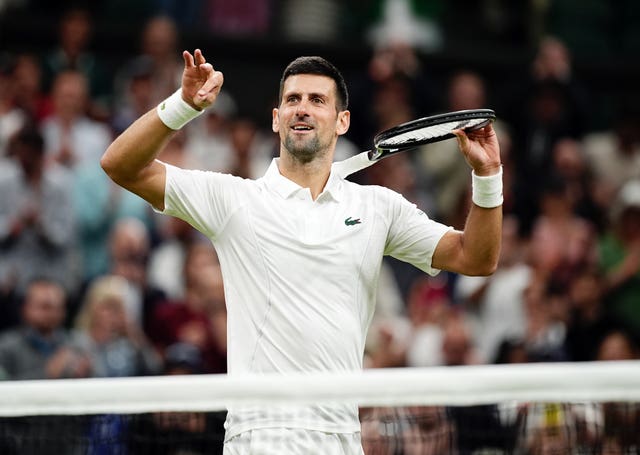 Novak Djokovic celebrates by pretending to play his racket like a violin